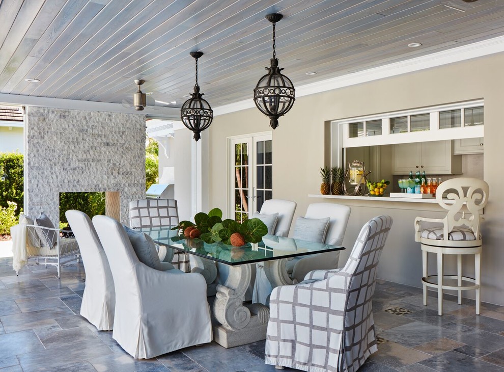 Beach style veranda in Miami with a roof extension and a bar area.
