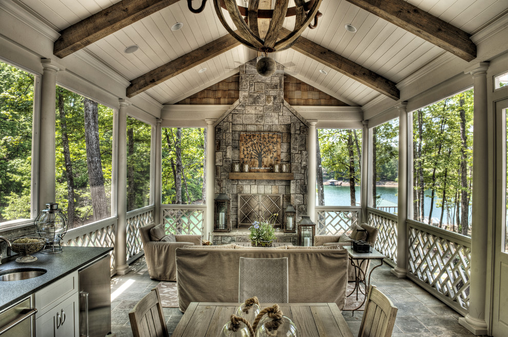 Inspiration for a mid-sized timeless stone back porch remodel in Other with a fire pit and a roof extension