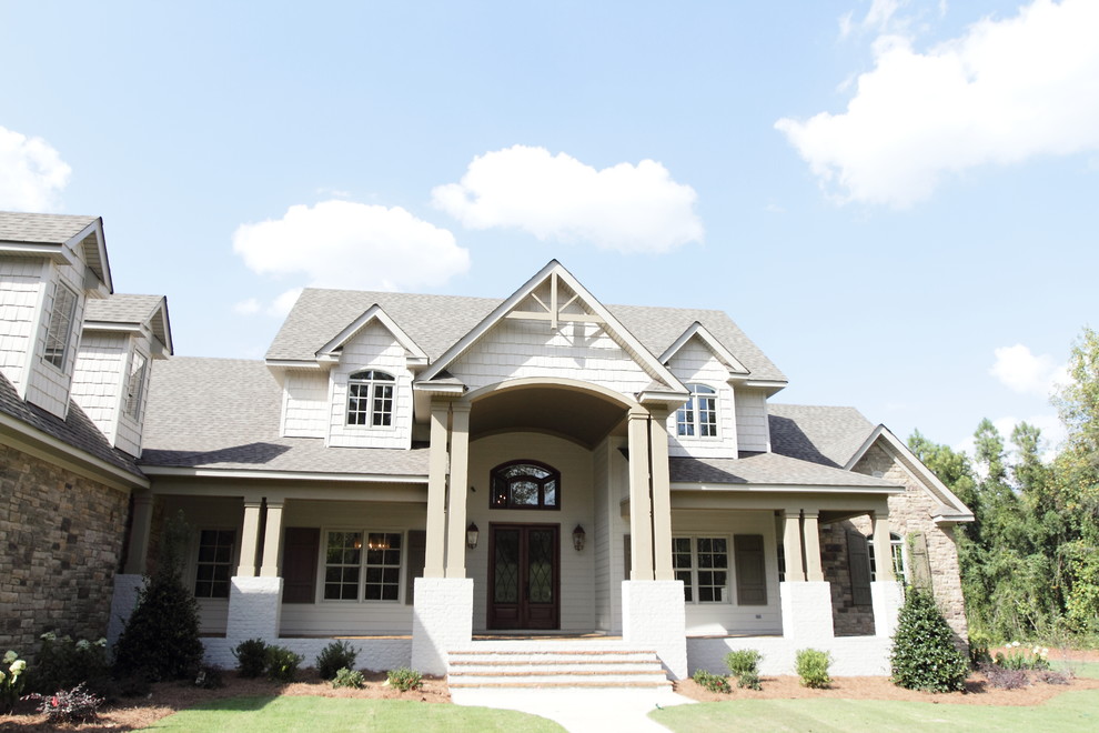Inspiration for a large rustic front porch remodel in Birmingham with a roof extension