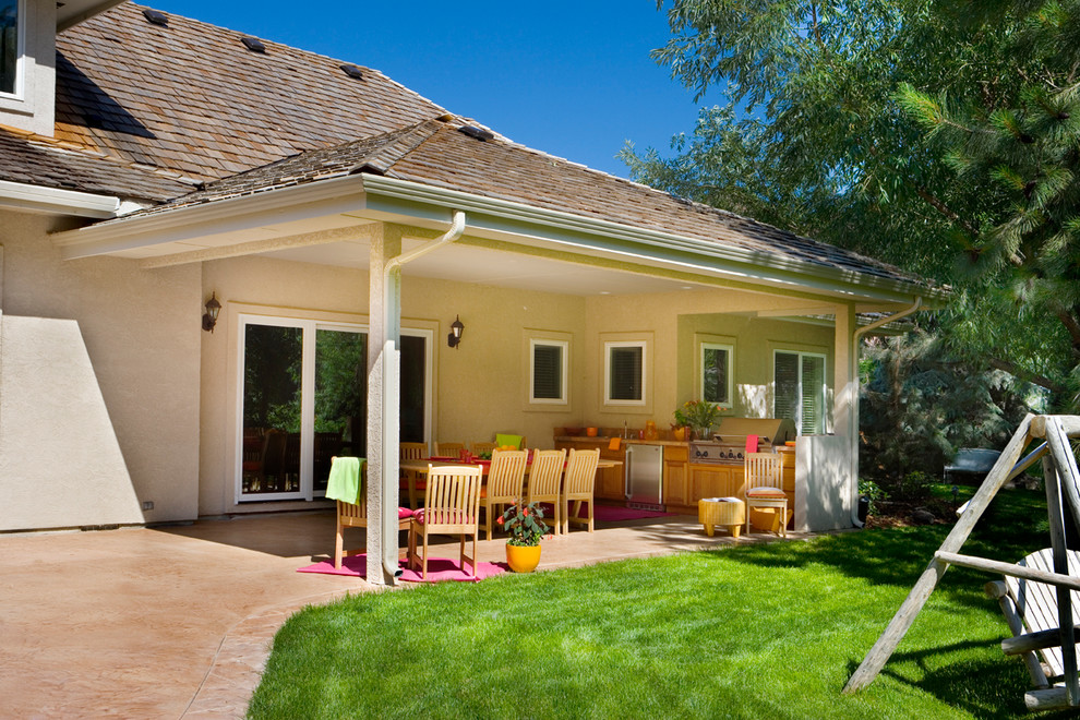 Mid-sized trendy stamped concrete porch idea in Boise with a roof extension