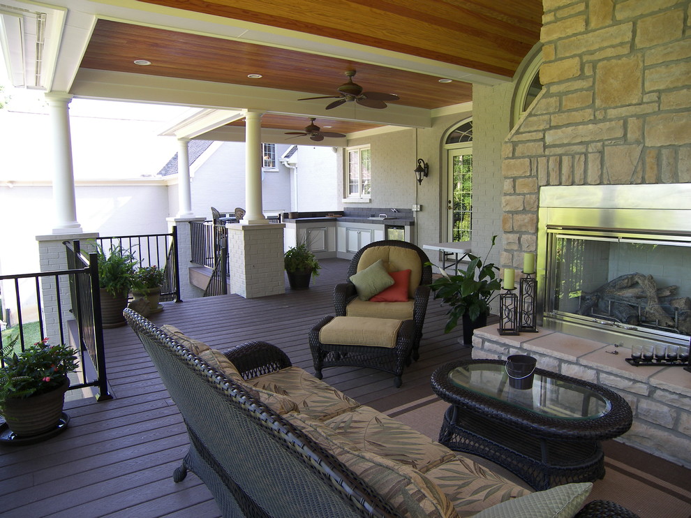 This is an example of a large traditional back porch design in Other with a roof extension.