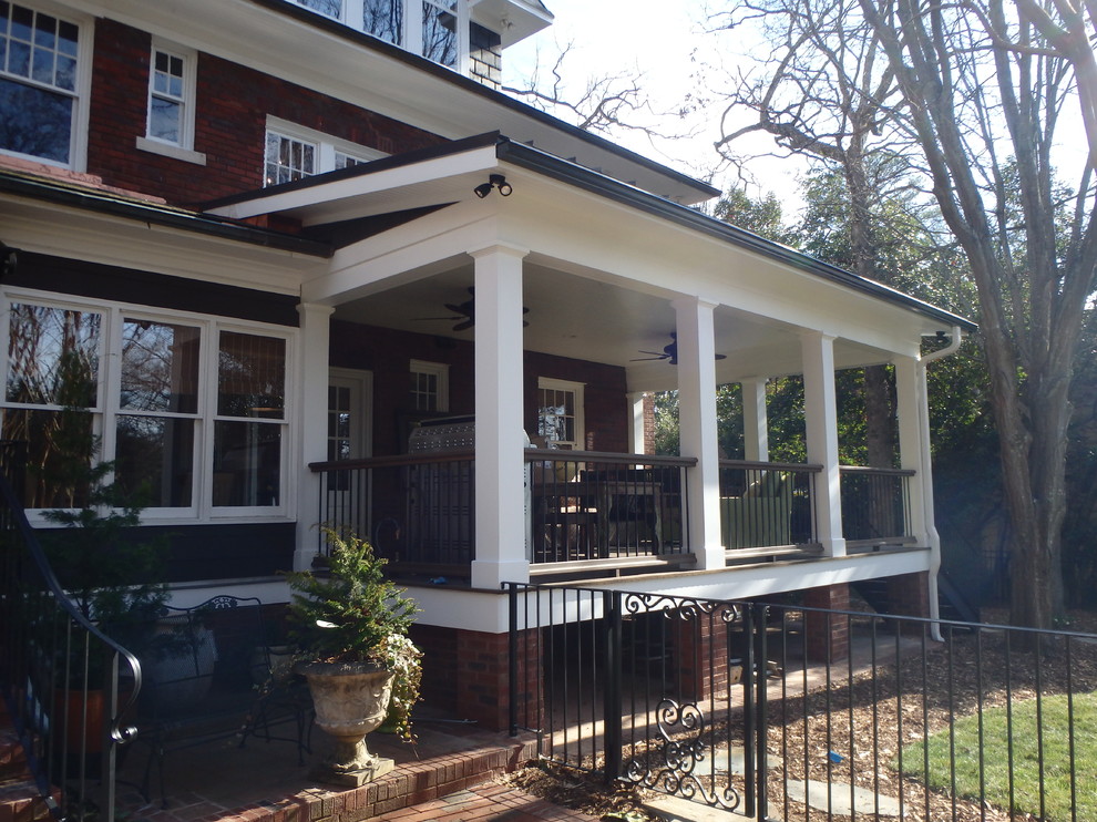 Large classic back porch idea in Charlotte with decking and a roof extension