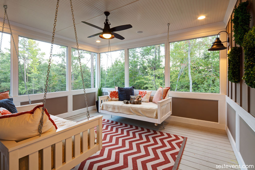 Elegant screened-in porch photo in Raleigh with decking and a roof extension