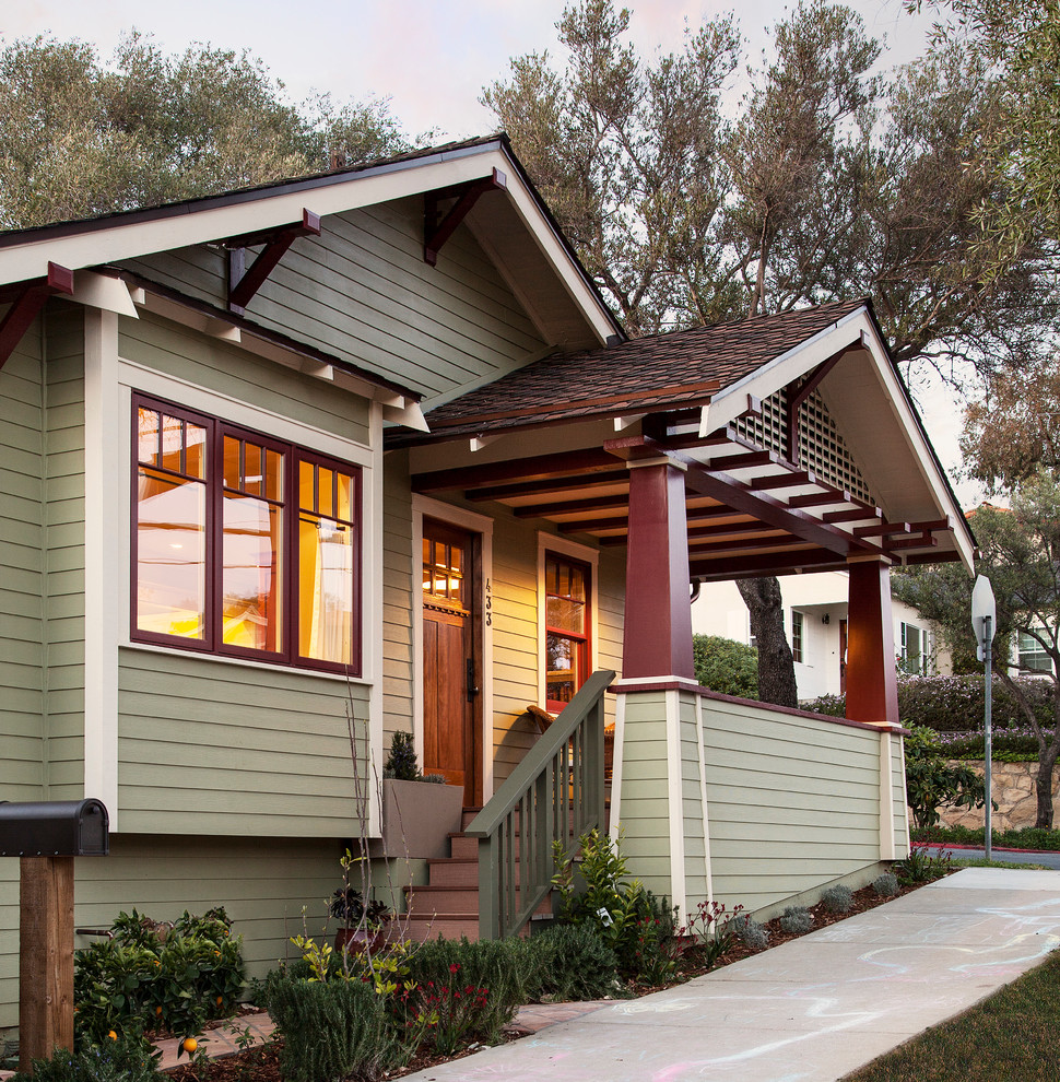 This is an example of a small craftsman front porch design in Santa Barbara with a roof extension.