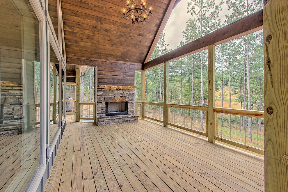 Inspiration for a mid-sized craftsman front porch remodel in Atlanta with a fireplace, decking and a roof extension