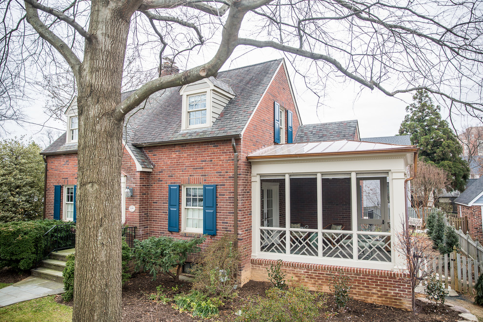 Mid-sized arts and crafts stone screened-in side porch idea in DC Metro with a roof extension