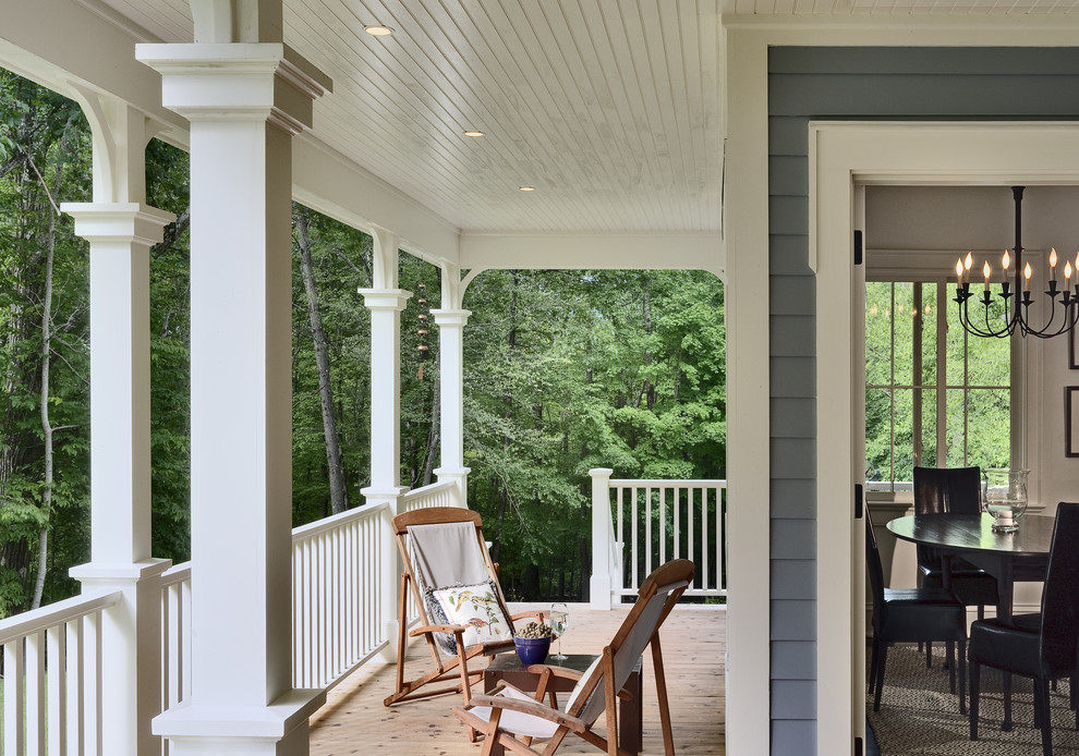 This is an example of a traditional porch design in New York with decking and a roof extension.
