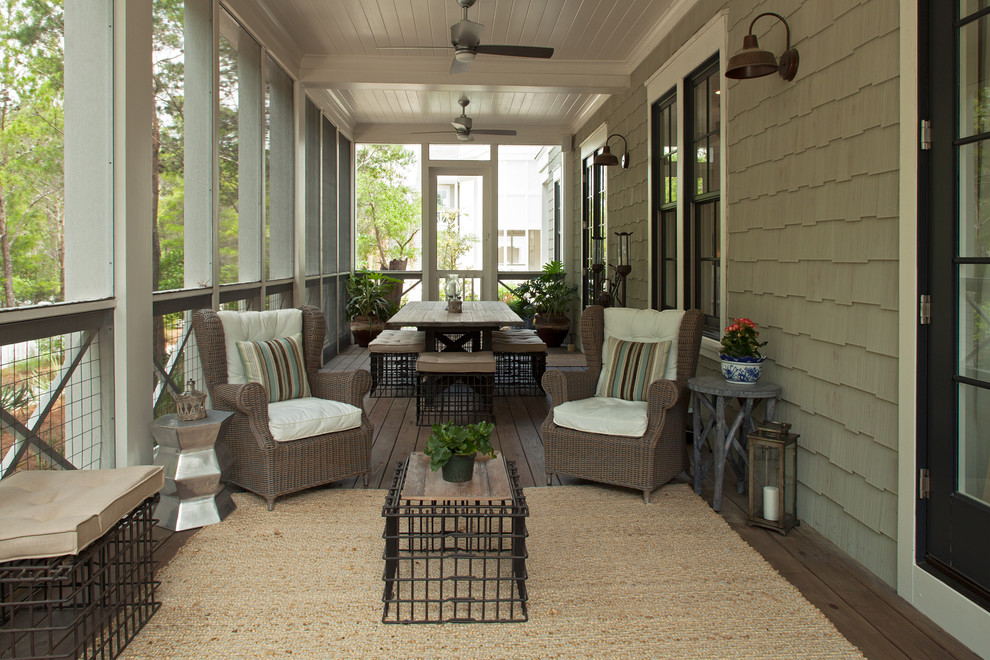 This is an example of a traditional screened-in front porch design in Miami.