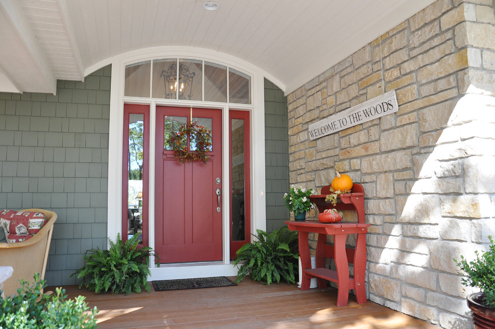 This is an example of a traditional front porch design in Other with decking and a roof extension.