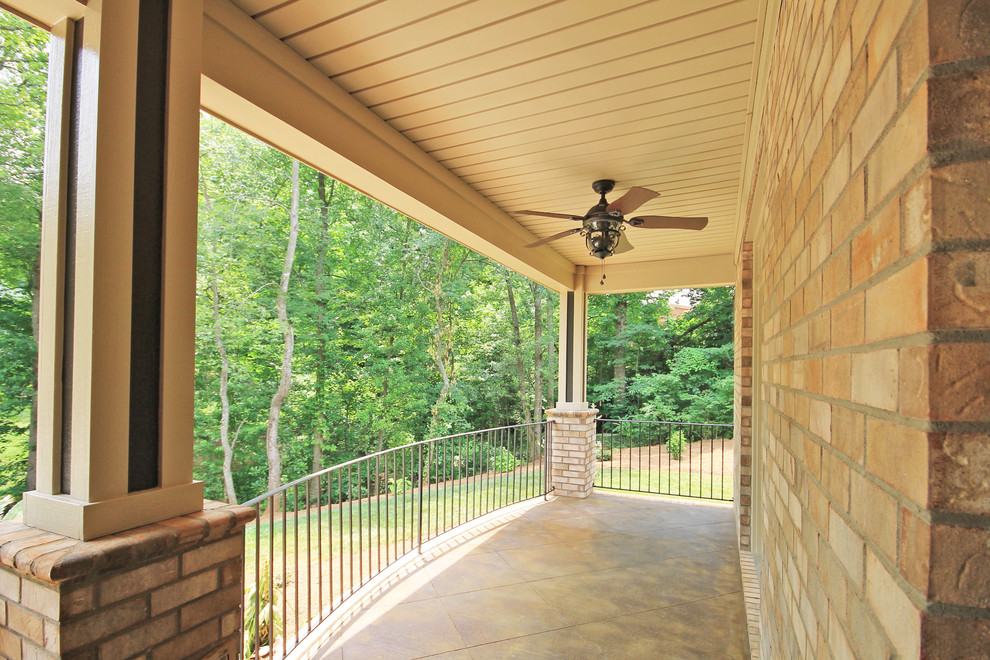 Design ideas for a classic front veranda in Other with stamped concrete and a roof extension.