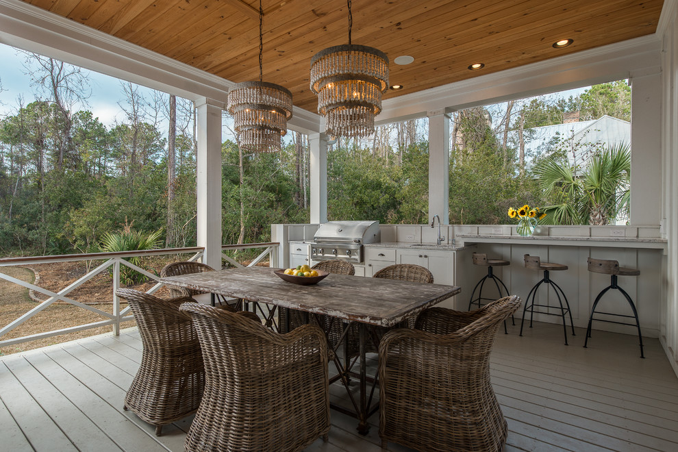 Beach style porch idea in Charleston with decking and a roof extension