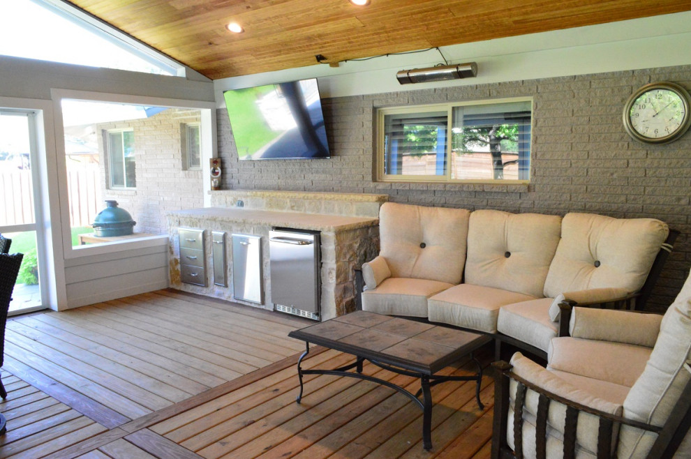 Huge 1960s stamped concrete back porch idea in Dallas with a fire pit and a roof extension