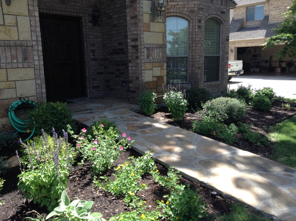 Large southwest stone front porch idea in Dallas with a roof extension