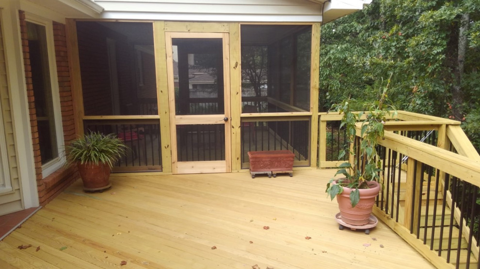 Large screened-in and mixed material railing back porch idea in Birmingham