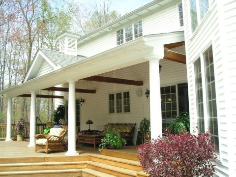 Photo of a large traditional back veranda in Cleveland with decking and a roof extension.