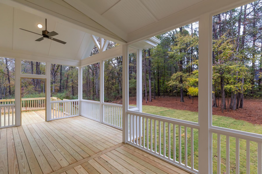 Photo of a large rural back screened veranda in Raleigh with decking and a roof extension.