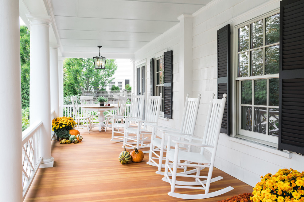 Large elegant front porch photo in Boston with a roof extension