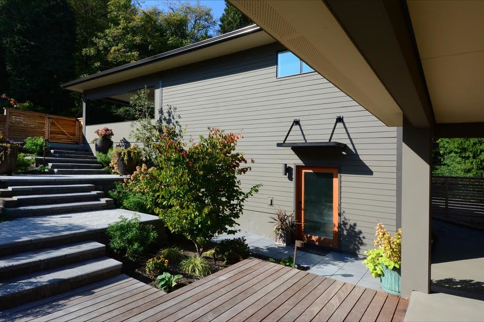 Inspiration for a large porch remodel in Seattle with a roof extension