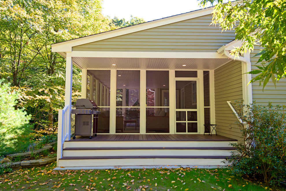 Inspiration for a mid-sized eclectic screened-in back porch remodel in Boston with decking and a roof extension