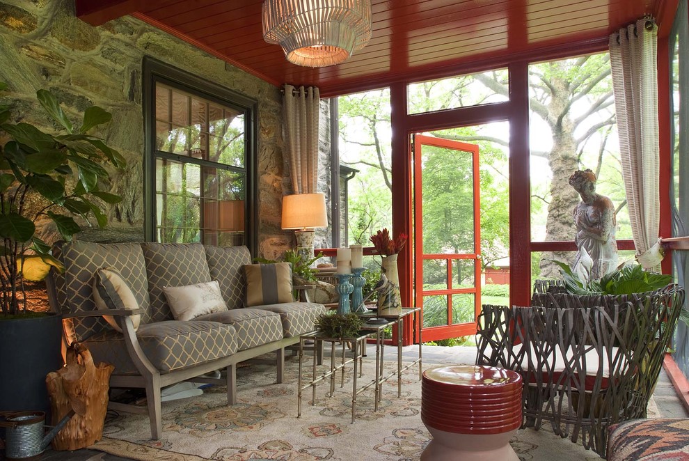 Inspiration for a small eclectic stone back porch remodel in Philadelphia with a roof extension