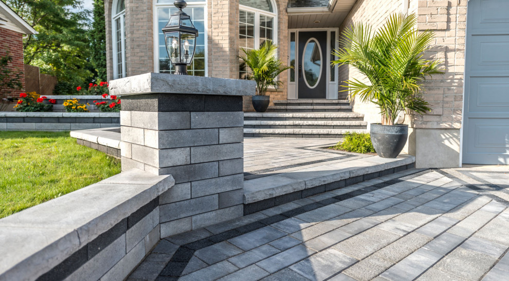 This is an example of a contemporary front veranda in Toronto with concrete paving.