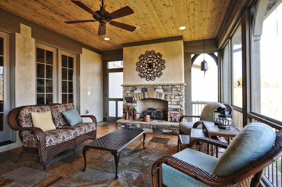 This is an example of a traditional porch design in Charlotte with a fire pit.
