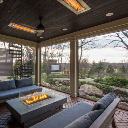 Design ideas for a contemporary back veranda in Chicago with a fire feature, brick paving and a roof extension.