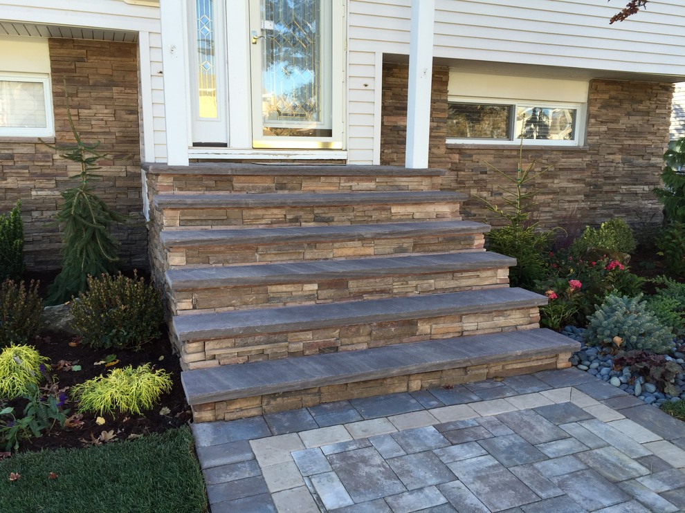 Inspiration for a mid-sized timeless concrete paver front porch remodel in New York