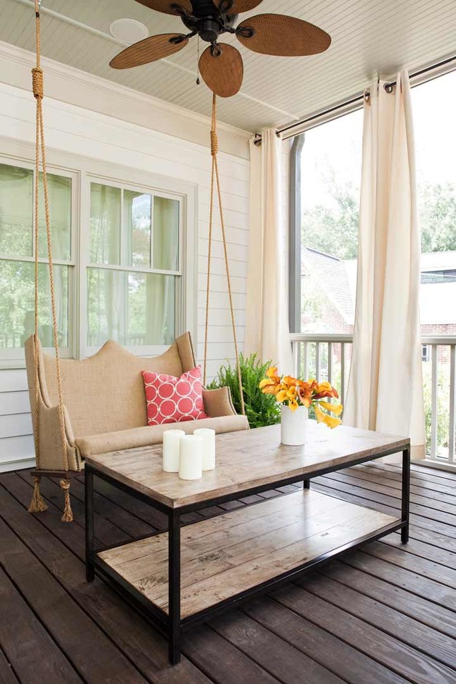 This is an example of a mid-sized traditional back porch design in Atlanta with decking and a roof extension.