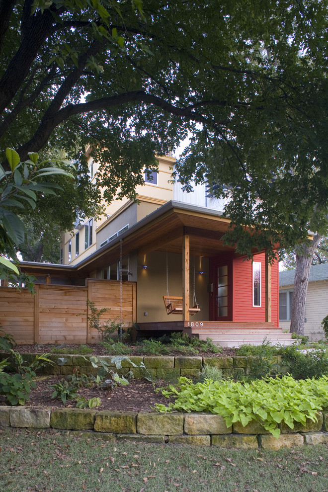 Inspiration for a small modern front veranda in Austin with decking and a roof extension.