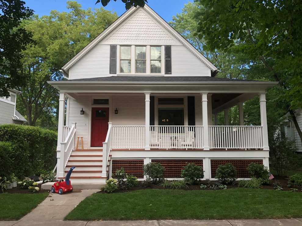 This is an example of a victorian front porch design in Boston with a roof extension.