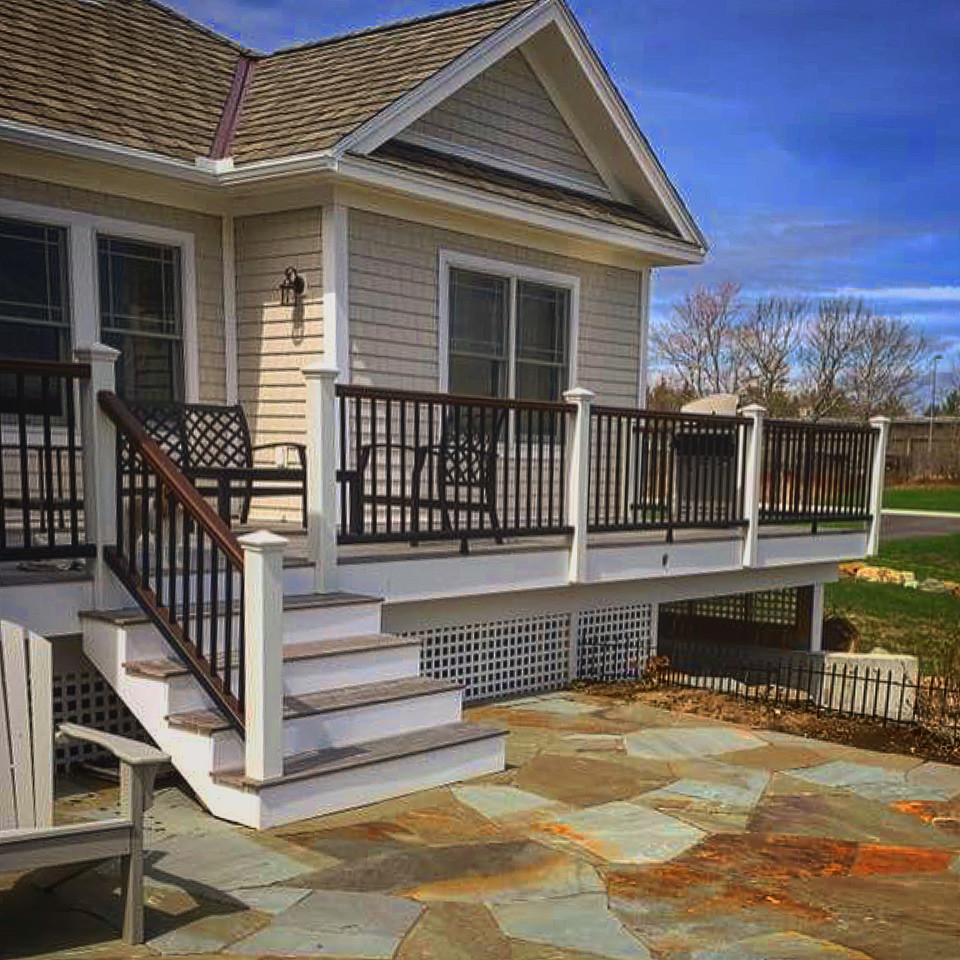 This is an example of a medium sized contemporary back veranda in Portland Maine with decking.