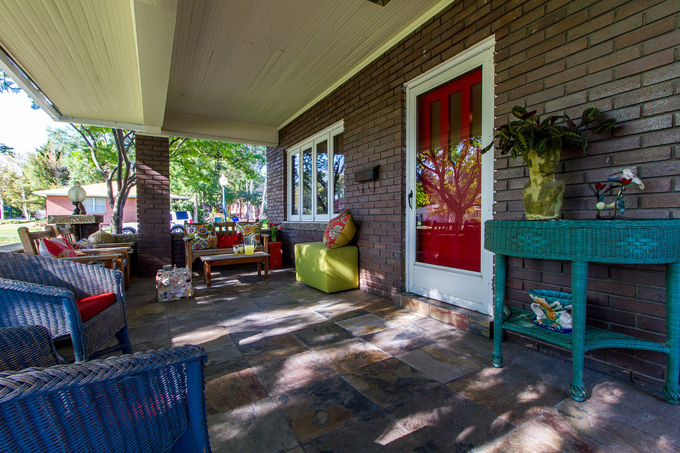 Inspiration for a medium sized eclectic front veranda in Salt Lake City with natural stone paving and a roof extension.