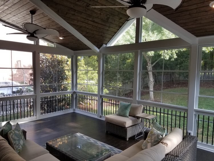 Mid-sized transitional screened-in back porch photo in Charlotte with decking and a roof extension