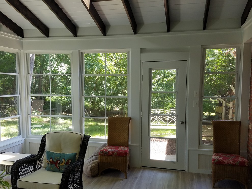 This is an example of a large traditional screened-in back porch design in DC Metro.