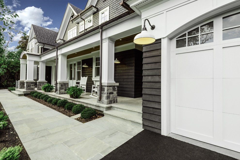 This is an example of a mid-sized traditional stone front porch design in Toronto.