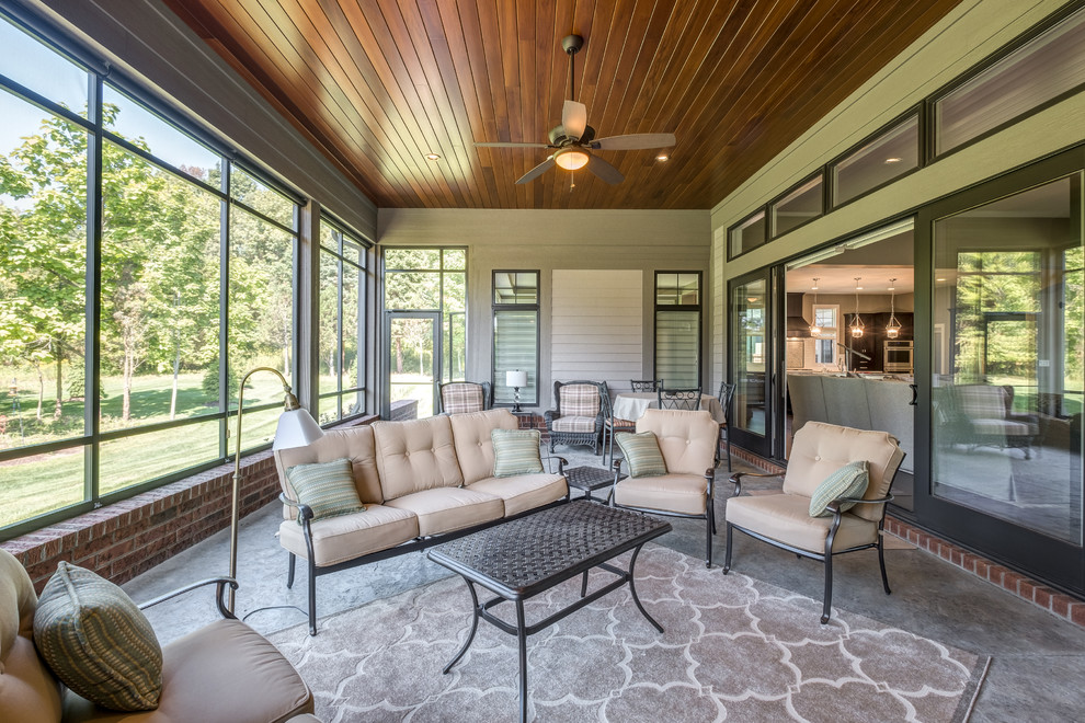 This is an example of a traditional screened-in porch design in Other with a roof extension.