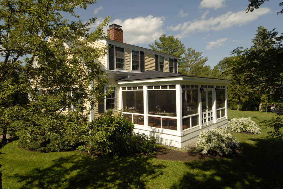 Large classic side screened veranda in Portland Maine with a roof extension.