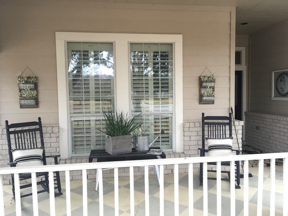 Cottage concrete front porch photo in Houston with a roof extension