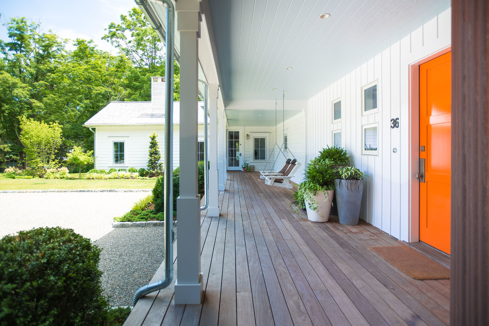 Mid-sized cottage front porch idea in New York with decking and a roof extension