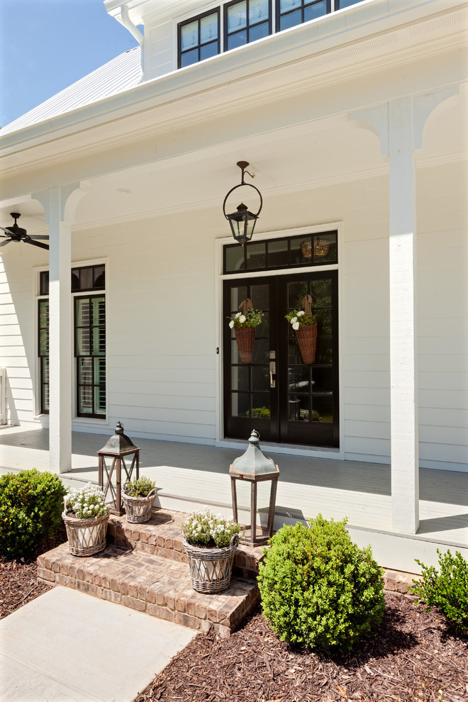 This is an example of a cottage front porch design in Atlanta.