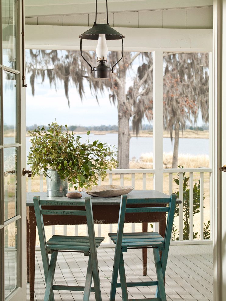 This is an example of a coastal porch design in Atlanta with decking and a roof extension.