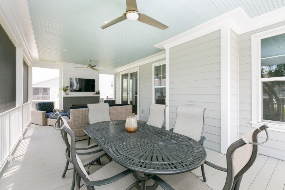 This is an example of a medium sized coastal back screened veranda in Charleston with a roof extension.