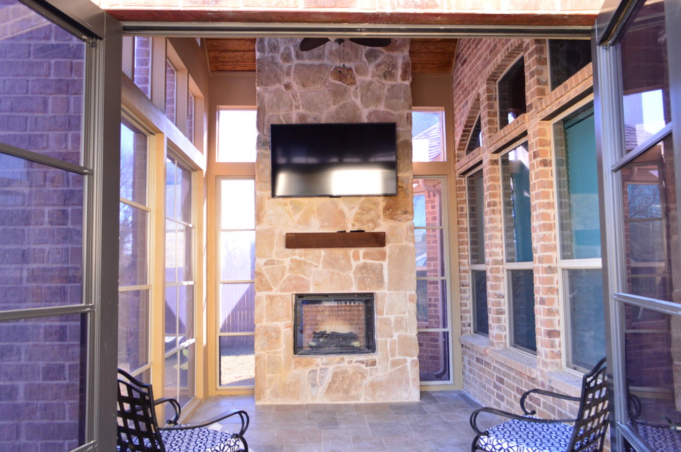 Inspiration for a rustic stamped concrete porch remodel in Dallas