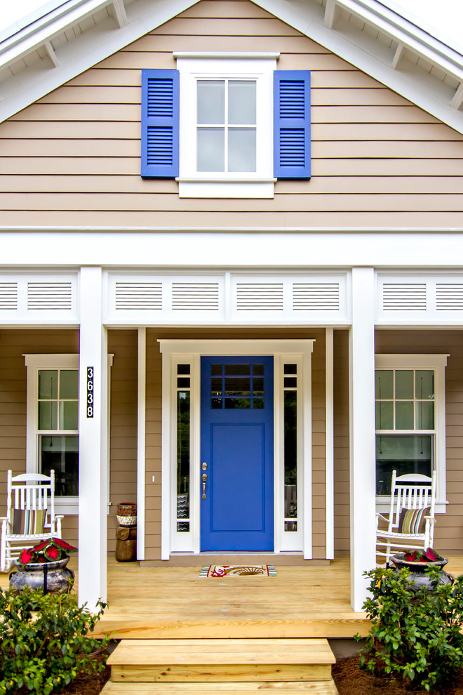 Small beach style front porch photo in Jacksonville with decking and a roof extension