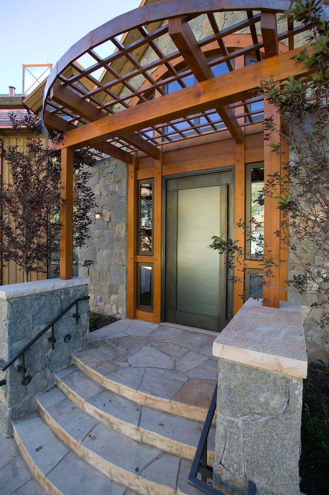 This is an example of a contemporary porch design in Denver with a pergola.