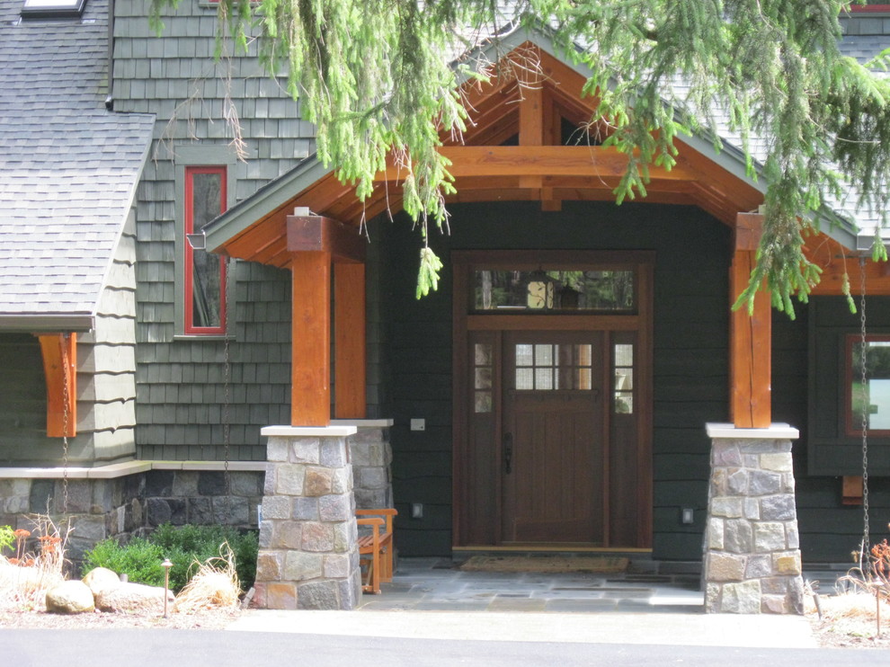 Aménagement d'un porche d'entrée de maison avant montagne avec des pavés en pierre naturelle.