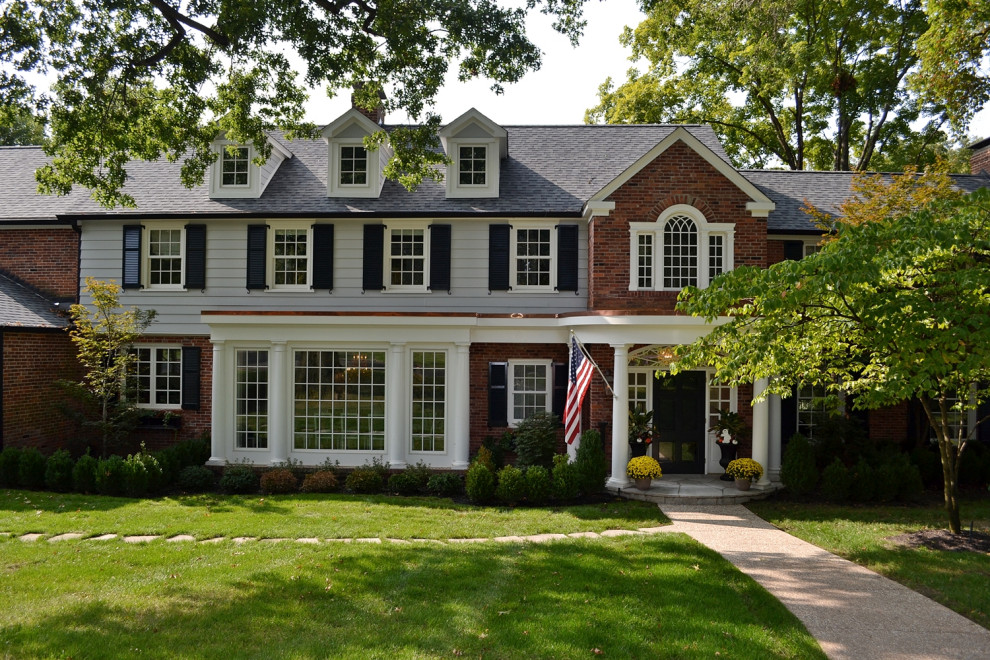 Mid-sized classic stone porch idea in St Louis with a roof extension
