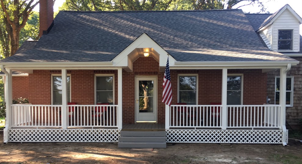 Mid-sized cottage front porch idea in Raleigh with a roof extension