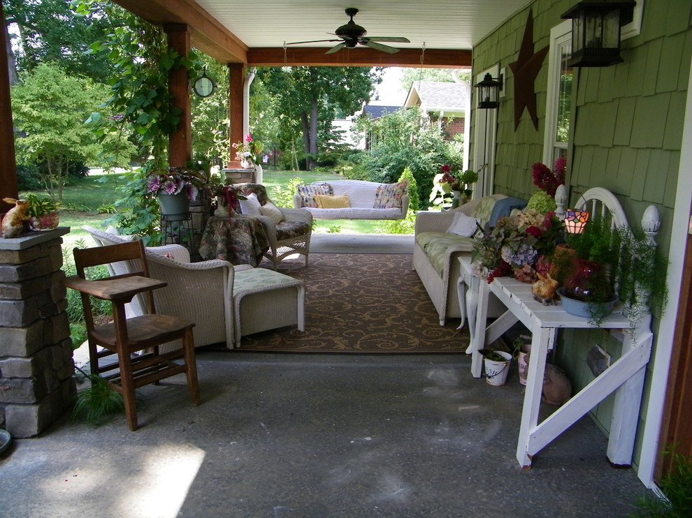 Arts and crafts concrete porch idea in Charlotte with a roof extension